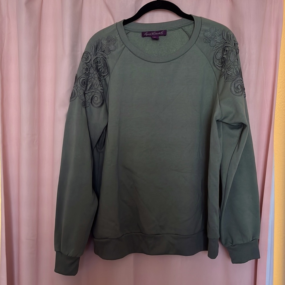 Cute cozy women’s large sweater with lace shoulder detail.